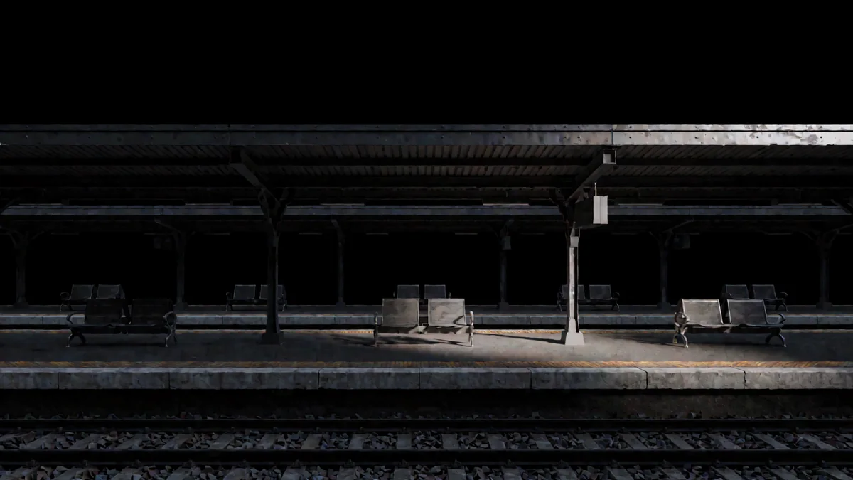 Un andén de estación ferroviaria con techo de chapa y bancos vacíos en penumbra