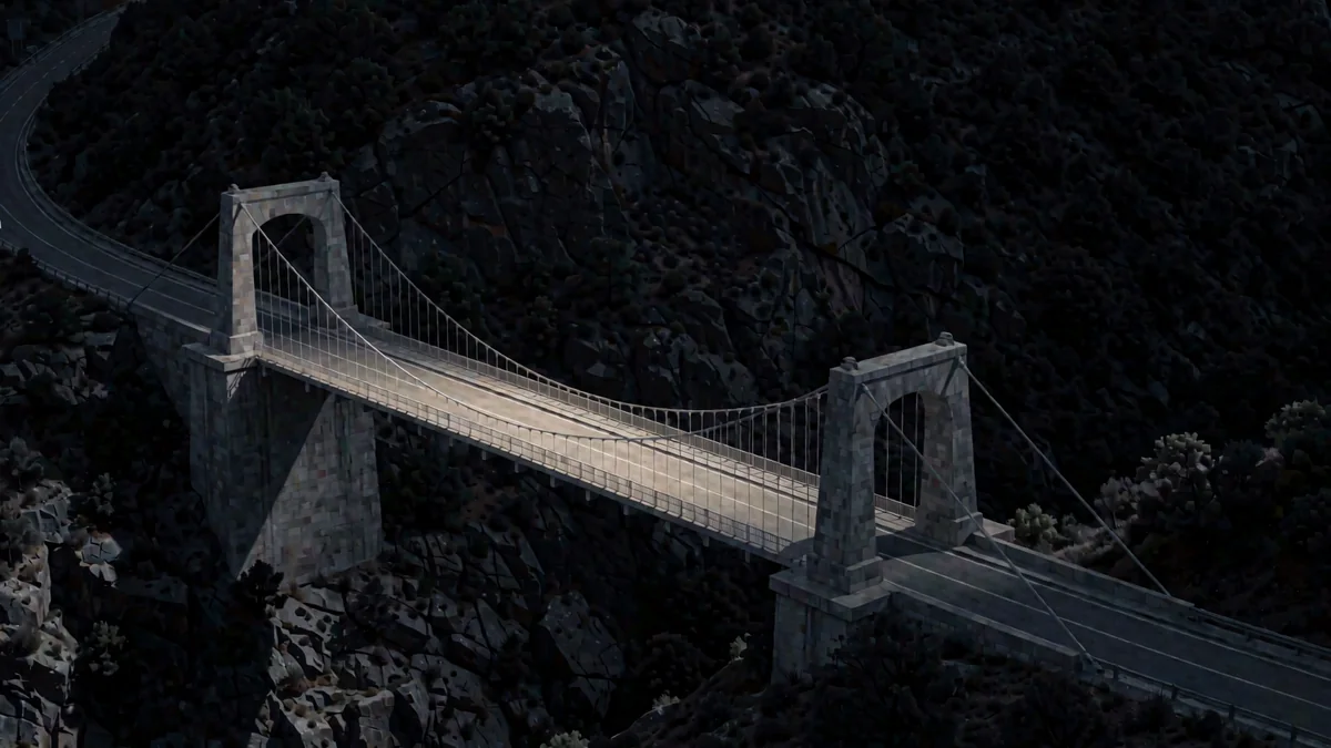 Un puente atirantado sobre un barranco de la sierra en hora azul con una luz cálida en la carretera